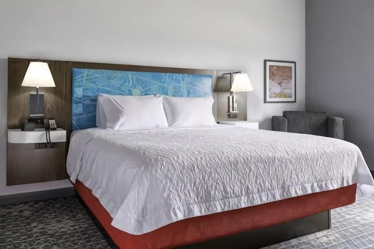 Premium bedding, desk, laptop workspace, blackout drapes