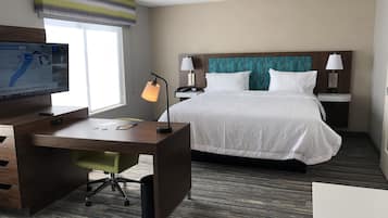 Premium bedding, desk, laptop workspace, blackout drapes