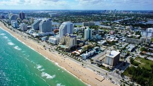 Un paisaje urbano costero con edificios altos, una playa y un río.