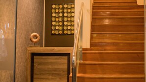 A staircase with wooden steps and metal railings, leading to an upper floor. - Murano Hotel (Moyobamba)