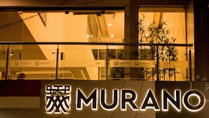 A hotel entrance with a sign reading "MURANO HOTEL" and a motorcycle parked outside. - Murano Hotel (Moyobamba)
