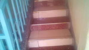 A staircase with red steps and a blue railing. - Sky Guest House (Nairobi)