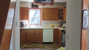 A kitchen with wooden cabinets, a Bosch refrigerator, and a window. - Fishing, Boating, Golf , Hunting - perfect getaway. Near Augusta for Masters (McCormick)