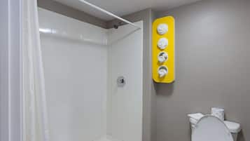 A bathroom with a shower, toilet, and a yellow towel rack.