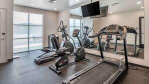 A gym with treadmills, elliptical machines, and a mirrored wall. - Extended Stay America Suites Colonial Heights Fort Lee (Colonial Heights)