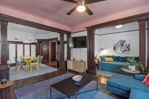 Relax in this inviting living space with a comfortable sofa, flat-screen TV, and dining area.