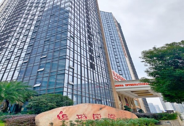 A modern high-rise building with a glass facade and a sign that reads 'China International'.