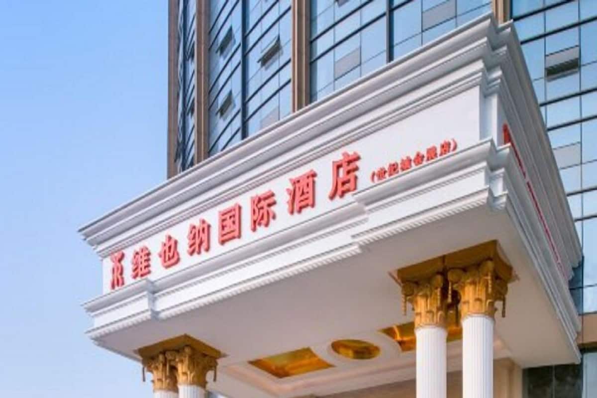 A hotel with a classical architectural style, featuring columns and a prominent entrance sign.