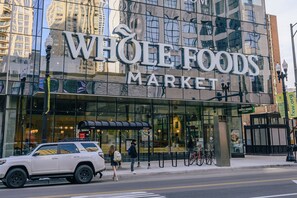 A Whole Foods Market with a glass storefront and a covered entrance. - Kasa Magnificent Mile Chicago (Chicago)