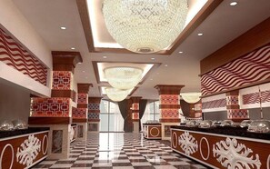 A hotel lobby with checkered flooring, decorative columns, and chandeliers. - Azur Resort & Spa Hotel (Alanya)