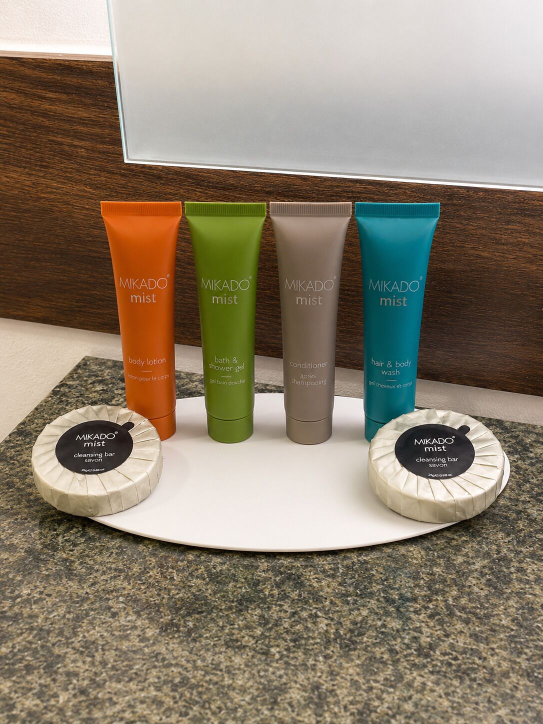 Four Mikado mist bottles and two cleansing bars on a countertop.