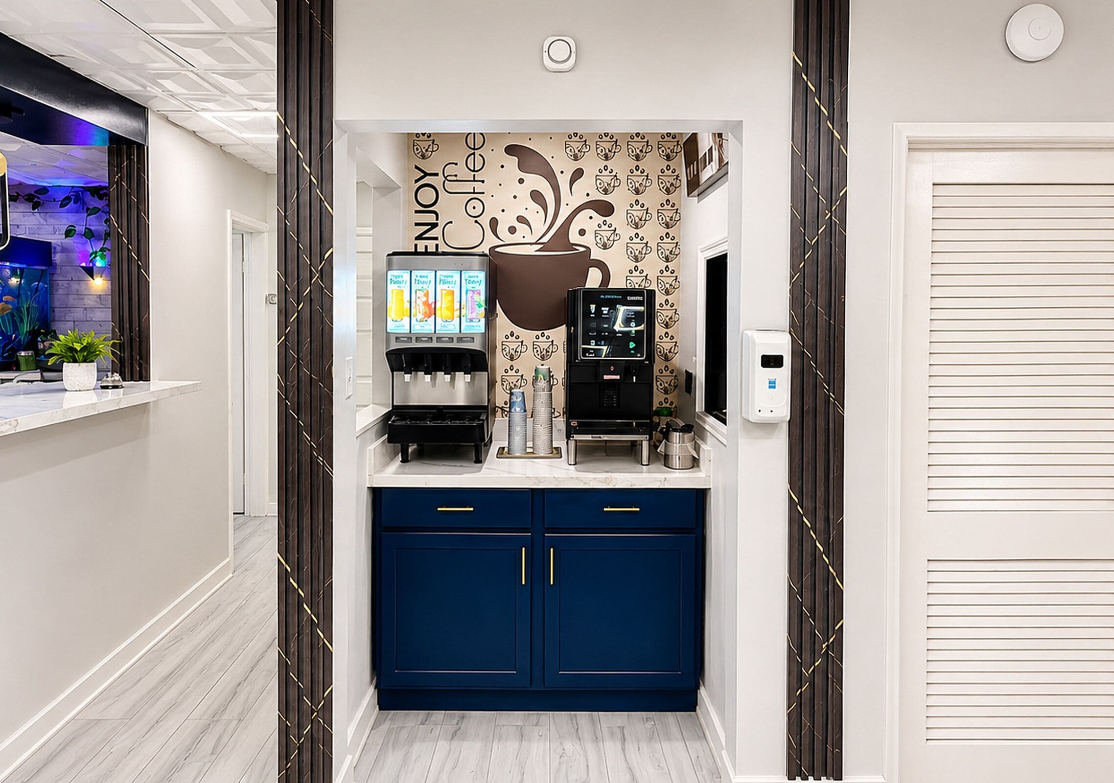 A coffee station with a coffee machine, a milk frother, and a coffee dispenser.