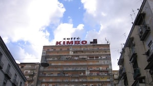 A multi-story building with balconies and a sign reading "caffe KIMBO". - B&B Bethel Napoli (Naples)