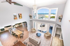 A spacious interior with a dining area, kitchen, and seating space with a view of the beach. - OCEANFRONT, 17 BRs, Ocean Views, Priv Pool, Rec Rm, Theatr Rm! 4x1487, The Dream (Corolla)