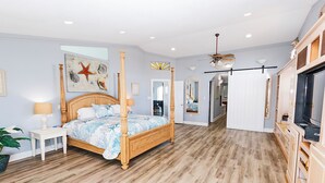 A spacious bedroom with a wooden four-poster bed, a ceiling fan, and a large mirror. - OCEANFRONT, 17 BRs, Ocean Views, Priv Pool, Rec Rm, Theatr Rm! 4x1487, The Dream (Corolla)