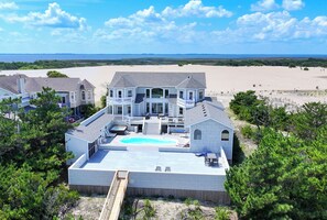 A large house with a swimming pool, multiple decks, and a view of the beach. - OCEANFRONT, 17 BRs, Ocean Views, Priv Pool, Rec Rm, Theatr Rm! 4x1487, The Dream (Corolla)