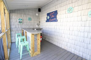 A small bar area with stools and a counter, wooden walls, and a motivational sign. - OCEANFRONT, 17 BRs, Ocean Views, Priv Pool, Rec Rm, Theatr Rm! 4x1487, The Dream (Corolla)