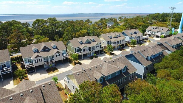 A residential area with multiple two-story houses, each featuring a garage and a front yard. - Oceanside, Patio, Hot Tub, Rec Room, BV8A, Break Away (Corolla)