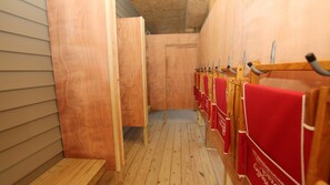 A row of wooden stalls with red towels, wooden benches, and a wooden ceiling. - OCEANFRONT, Ocean Views, Private Beach Walkway! NH1, Blackbeard's JEM (Nags Head)