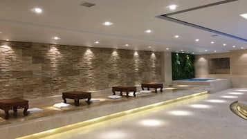 A spa area with stone walls, benches, and a reception desk.