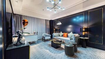 A modern living room with a pool table, a sofa set, and a chandelier.