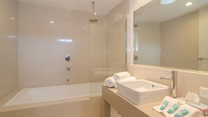 A modern bathroom with a glass-enclosed shower, a large bathtub, and a vanity with a mirror. - Seine Bay Apartment (1 bedroom) modern accommodation in the townsite - Seine Bay Apartment (1 bedroom) (Augusta)