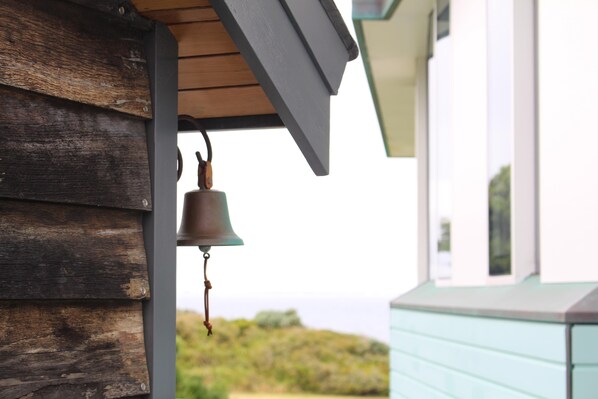 A wooden exterior wall with a hanging bell. - Boathouse - nearly in the water and wonderful views - Boathouse - nearly in the water (Augusta)