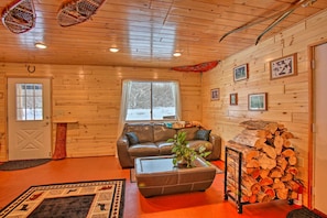 Relax in this inviting living room with a leather sofa, coffee table, and potted plant.