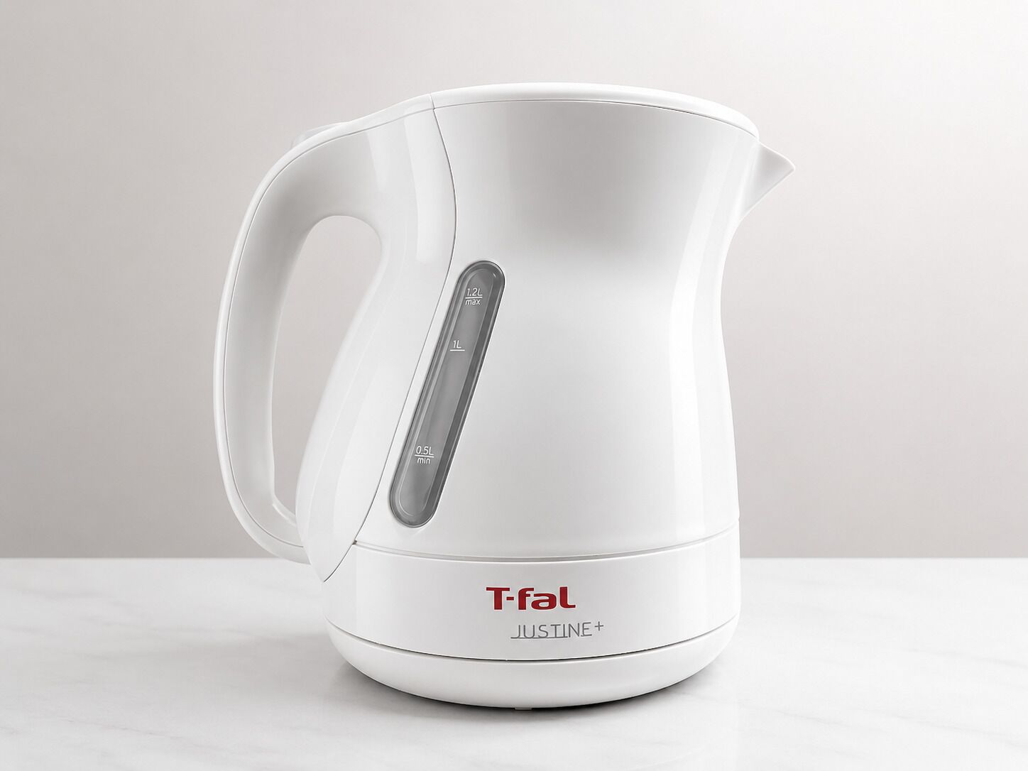A white T-fal Justine+ electric kettle with a digital display and a handle.
