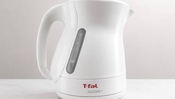 A white T-fal Justine+ electric kettle with a digital display and a handle.