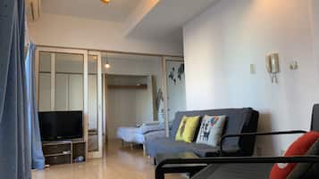 1 Bedroom Apartment | Living area | Flat-screen TV
