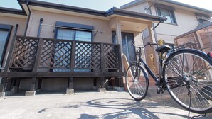 A modern two-story house with a balcony and a bicycle parked outside. - Okazaki House up to 8 People (Okazaki)