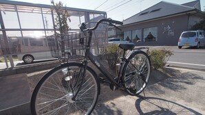 A bicycle parked in front of a building with a large window and a sign with Japanese characters. - Okazaki House up to 8 People (Okazaki)