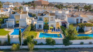 A coastal residential area with modern white houses, a central swimming pool, and a view of the sea. - Villa Blue Ocean by Interhome (Gale)