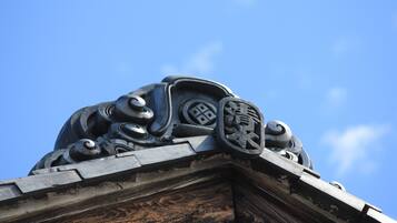 A detailed architectural feature with ornamental designs and inscriptions on a building's corner.