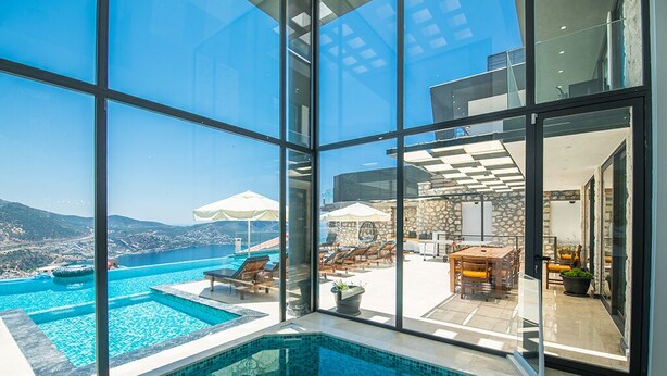 A modern indoor swimming pool with clear views of the sea and mountains. - Villa Unlimited Duo, luxury 6 bedroom villa (Antalya)