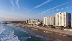 A coastal hotel with multiple high-rise buildings, beachfront access, and a pier. - Daytona Beach | Beach & Pool Access | 2BR Deluxe (Daytona)