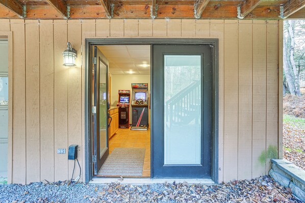 A wooden building with a door leading to a room containing arcade games. - Secluded Family Cabin w/ Fire Pit in Lake Ariel! (Lake Ariel)