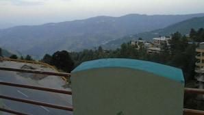 A mountainous landscape with buildings on the hills. - Marina Inn Guest House (Abbottabad)
