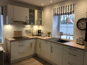 Fridge, stovetop, dishwasher, coffee/tea maker