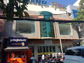 A building with large windows and a sign for 'Look Chin Jung'.