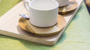 A tray with two white cups and a white teapot on a wooden board, placed on a green cloth. - Garden Otsuka 705 (Tokyo)