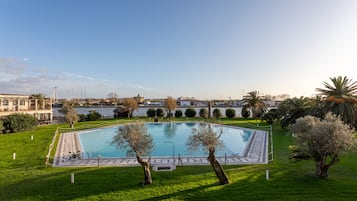 Seasonal outdoor pool, open 10:00 AM to 8:00 PM, pool umbrellas