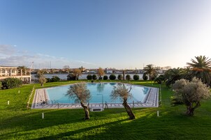 Seasonal outdoor pool, open 10:00 AM to 8:00 PM, pool umbrellas
