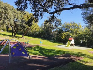 A playground with climbing structures and a slide.