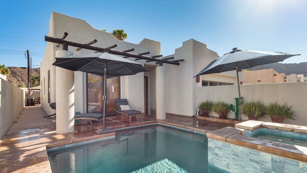 A swimming pool with a pergola and umbrellas, surrounded by a patio area with chairs and potted plants. - 222396 3BR Escape w/ Fire Pit: 1 Mi to Old Town (La Quinta)