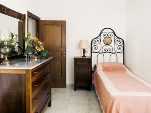 Cozy retreat with a bed, dresser, nightstand, and mirror.