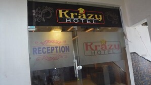 The entrance to the Krazy Hotel with a reception area visible through the glass doors. - Krazy Hotel (Haldwani)