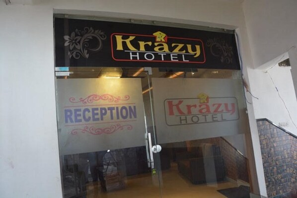 The entrance to the Krazy Hotel with a reception area visible through the glass doors.