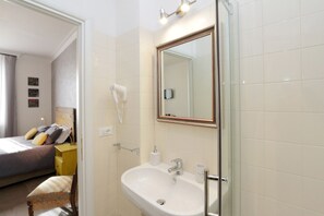 A hotel bathroom with a sink, mirror, and hairdryer. - B & B Li Rioni (Rome)